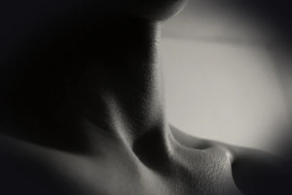 a black and white photo of a woman's neck