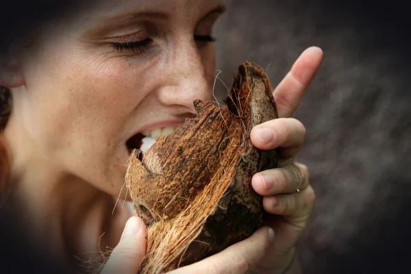 woman eating coconut meat