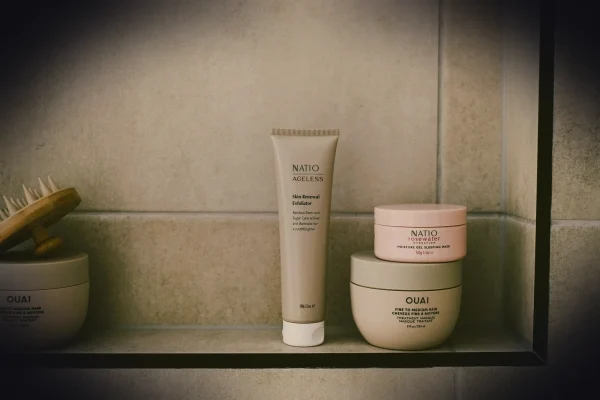 Beauty products are displayed neatly on a shelf.