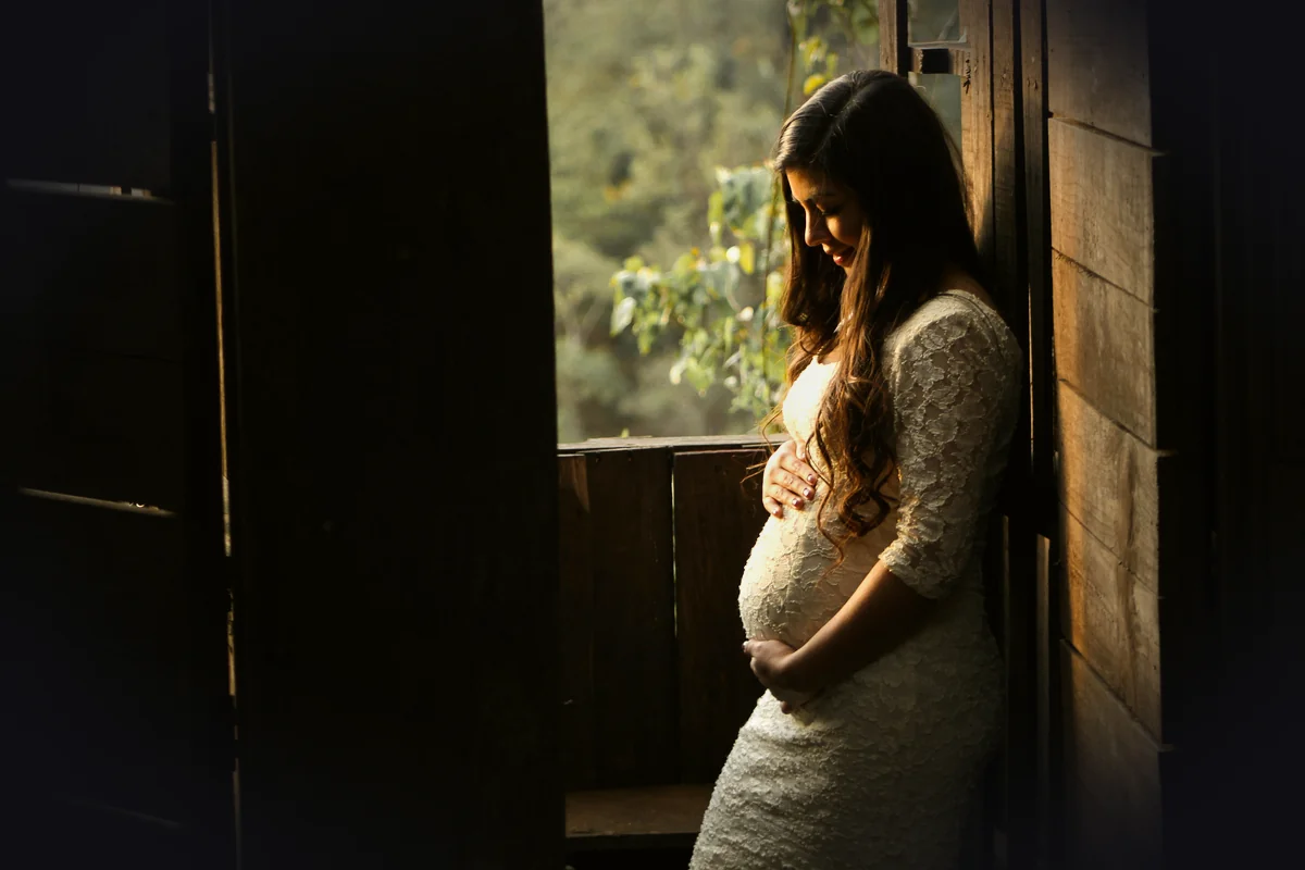 pregnant woman holding her womb