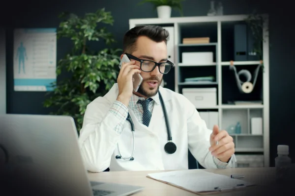 Doctor talking on the phone in his office.