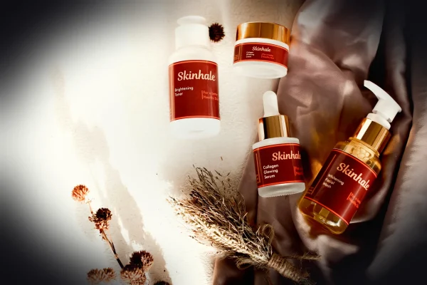 Skincare products are arranged on a beautiful surface.