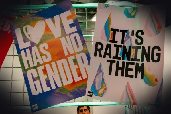 a man holding up a sign that says love has no gender