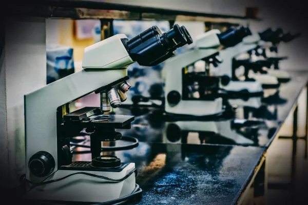 white microscope on top of black table