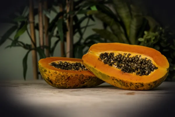 sliced papaya fruits on brown surface