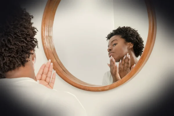 man wearing white shirt facing on wall mirror