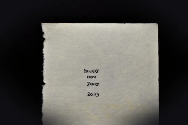 a piece of paper with the words happy new year written on it