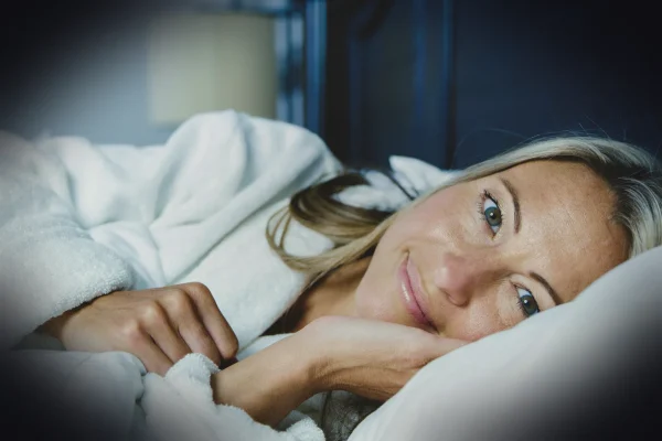 woman lying on bed