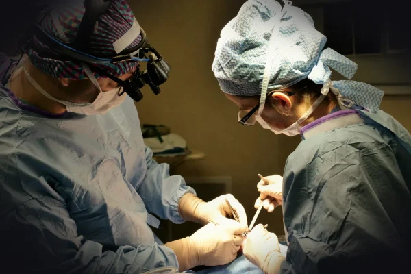 Surgeons performing a medical procedure in an operating room.