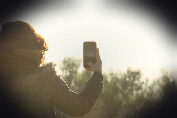 a person taking a picture with a cell phone