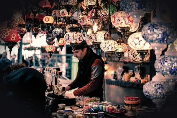 bazaar, booth, bracelets, candles, commerce, group, lamps, man, market, merchant, people, person, sale, sell, shop, shop