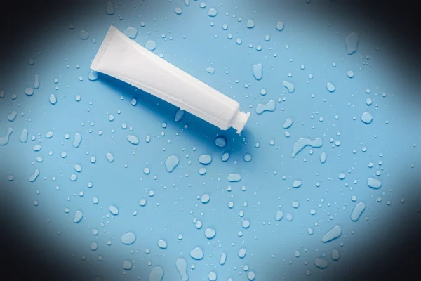 white tube on pink surface