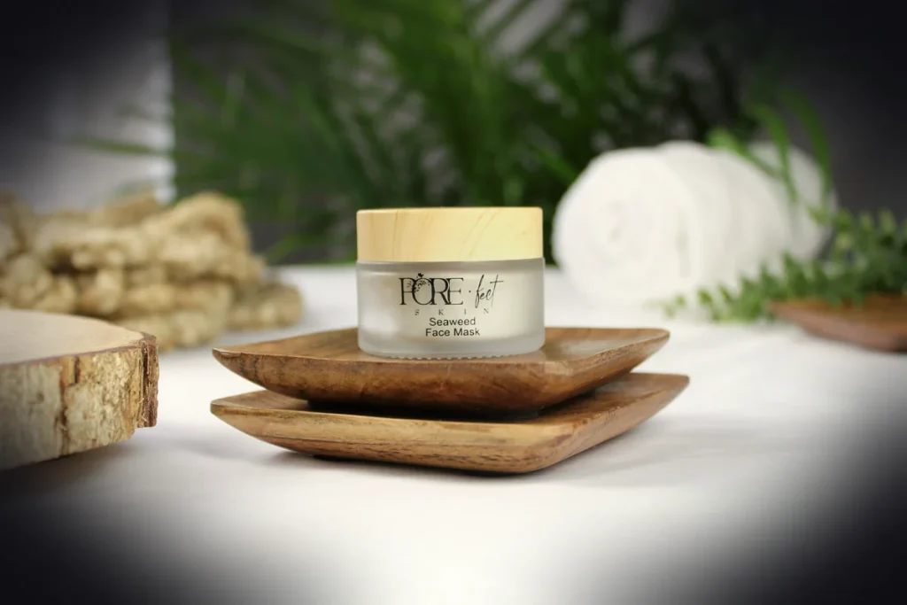 A small jar of face cream on wooden dishes