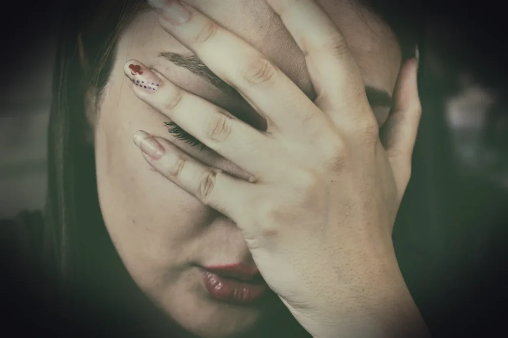 woman's hand on face